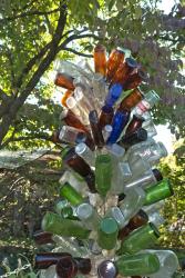 Click to enlarge image  - Bud Quigley's Bottles - Mrs. Quigley put her husbands bottle collection to good use with 14 bottle trees.